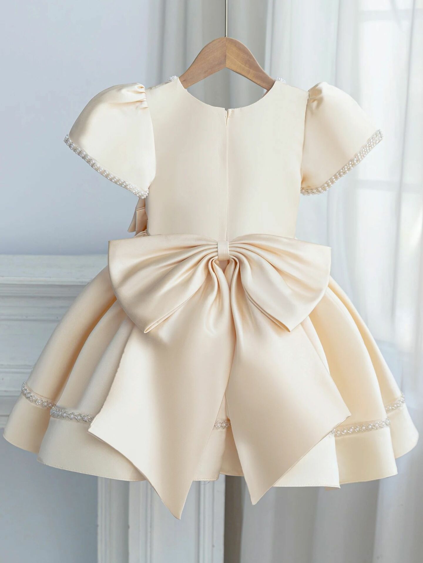 Agnes Champagne Satin Pearl-Trimmed Short Sleeve Young Girls Formal Dress with Oversized Bow | Lucys